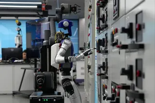 Artificial Intelligence robots demonstrate working on power grid control units during a media tour at Guangdong Power Grid Robotics Laboratory in Guangzhou, Guangdong province, on April 16. AP: Andy Wong
