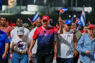 Cuba’s President Miguel Diaz-Canel (centre, in red hat) marches in a May Day parade in Havana, Cuba, on Friday. Photo: pool via Reuters