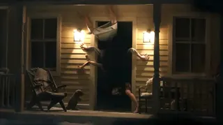 Arms and legs fly out of a dark doorway.