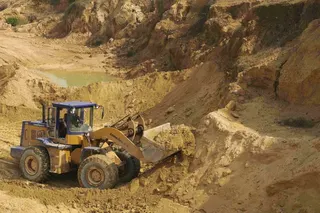 A skip loader shifts earth at a rare earth metals mine in China’s Jiangxi province. Photo: Reuters