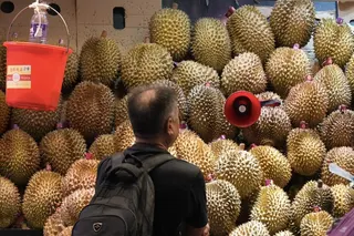 A shopper browses a mound of durians at a market in Hong Kong. Photo: Eugene Lee