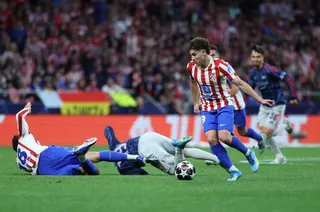 Atletico Madrid's Spanish defender #18 Marc Pubill (L) and Arsenal's Belgian midfielder #19 Leandro Trossard (C) fall down to the ground while Atletico Madrid's Argentine forward #19 Julian Alvarez runs with the ball during the UEFA Champions League semi-final first leg football match between Club Atletico de Madrid and Arsenal at the Metropolitano stadium in Madrid on April 29, 2026.
