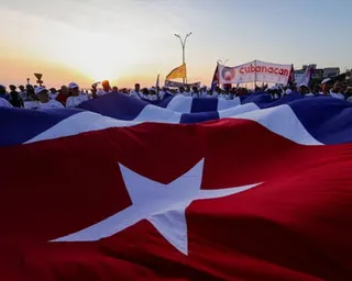 People hold giant Cuban flag during May Day rally in Havana