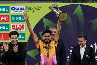 Pakistans cricket player and Peshawar Zalmi captain Babar Azam (C) celebrates after receiving the trophy from Pakistan Cricket Board (PCB) chairman Mohsin Naqvi (C, back) after winning the Pakistan Super League (PSL) Twenty20 final match against Hyderabad Kingsmen at the Gaddafi Stadium in Lahore on May 4, 2026. (Photo by Arif ALI / AFP)