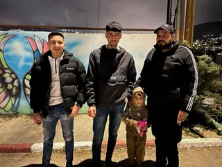 Three young people stand up