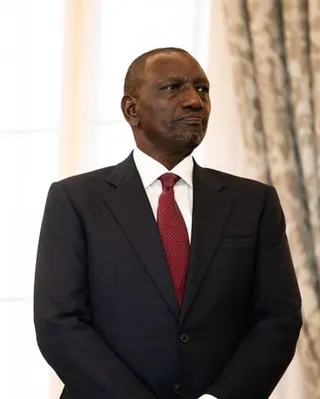 A middle-aged African man in a suit