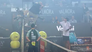 Spain's Rafael Jodar speaks with umpire Manuel Messina after smoke from the Coppa Italia final between Inter Milan and Lazio surrounds the court in his Italian Open quarter-final against Italy's Luciano Darderi
