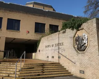 Steps lead to Southampton Crown Court entrance with 'Courts of Justice' text and a decorative coat of arms