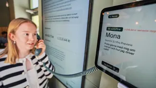 Hanna Petersson, a member of Andon Labs’ technical staff, uses a telephone handset to speak with Andon Café's AI agent 'Mona' in Stockholm, Sweden, Tuesday, May 5, 2026. (AP Photo/James Brooks)