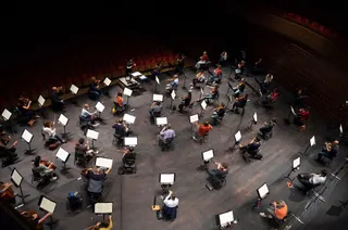 Chief Conductor Elim Chan, center top, conducts the Antwerp Symphony Orchestra through a rehearsal at the Queen Elisabeth Hall in Antwerp, Belgium, July 1, 2020. (AP Photo/Virginia Mayo, File)