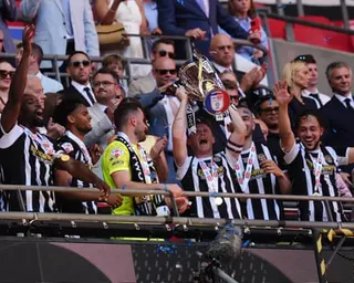 Notts County captain Matt Palmer lifts the trophy