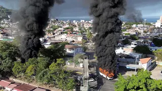 Smoke billows from burning vehicles on a highway in Puerto Vallarta, Jalisco, Mexico