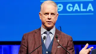 Boomer Esiason speaking on stage at New York Hilton Midtown.