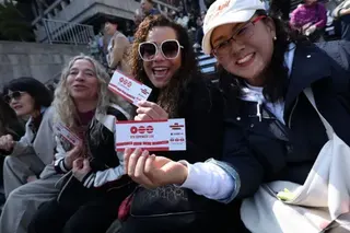 BTS fans in Seoul holding their tickets