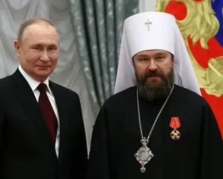 Bishop Hilarion with Russia's president, Vladimir Putin. Hilarion is wearing a medal.