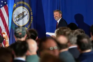 a man smiles at a crowd