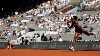 Coco Gauff hitting a backhand return during a tennis match