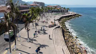 Tourists walking along the boardwalk in Puerto Vallarta Mexico