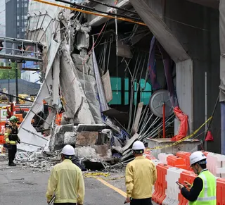 South Korean rescue teams inspect the scene where an overpass collapsed while it was being dismantled in Seoul on Tuesday. Photo: Yonhap/AP