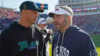 Tulane football coach Jon Sumrall and Mississippi football coach Pete Golding confer on the field