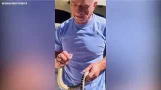 Robert F. Kennedy Jr. holding a rattlesnake