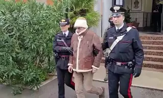This handout video grab taken and released by the Italian Carabinieri Press Office on January 16, 2023 shows the transfer of Italy’s top wanted mafia boss, Matteo Messina Denaro (centre) from the Carabinieri police station of San Lorenzo in Palermo, to an undisclosed location. — Italian Carabinieri Press Office handout via AFP