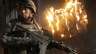 A soldier stands before a Seoul building on fire in Call of Duty: Modern Warfare 4