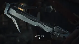 A close-up of the base of a sword blade being drawn from a sheath.