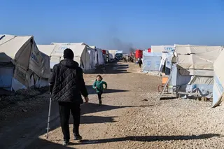 AL HASAKAH, SYRIA - JANUARY 26: Detainees are seen between tents at the al-Hol camp on January 26, 2026 in Al Hasakah, Syria. The al-Hol camp (also spelled Al-Hawl) in Syria's northeastern Hasakah province has come under control by Syrian government forces, following the withdrawal of the Kurdish-led Syrian Democratic Forces (SDF) in recent days. The camp houses around 24,000 people, many of whom are women and children, with alleged links to the jihadist group Islamic State (IS), also referred t