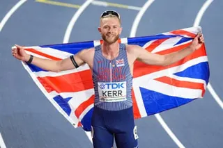 Josh Kerr celebrates winning 3,000m gold with the union jack flag in Torun, Poland