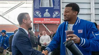 New Head Coach John Harbaugh shaking hands with New York Giants quarterback Jameis Winston at a press conference