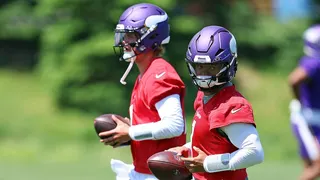 Kyler Murray wearing number 1 jersey participating in a drill at a football practice.