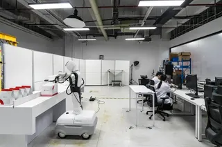 A robot learning to unpack and fold boxes at a lab working with Meituan in Shenzhen, China.