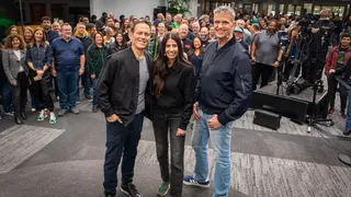Xbox trio Phil Spencer, Asha Sharma, and Matt Booty stand in a line before a large assembled crowd behind them.