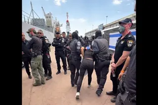 A screen grab from Israeli minister Itamar Ben Gvir’s X account shows a Gaza bound flotilla activist escorted with hands tied. — AFP pic/X account of Israel’s National Security Minister Itamar Ben Gvir