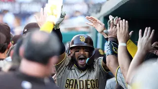 Fernando Tatis Jr. celebrating with teammates during a baseball game.