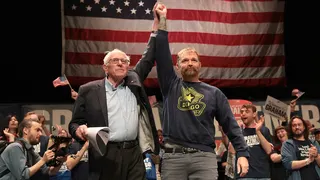 Sen. Bernie Sanders and Graham Platner standing together at the Collins Center for the Arts in Orono, Maine