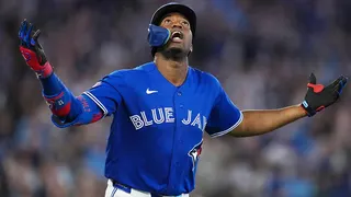 Toronto Blue Jays right fielder Jesus Sanchez celebrating after hitting a grand slam home run.