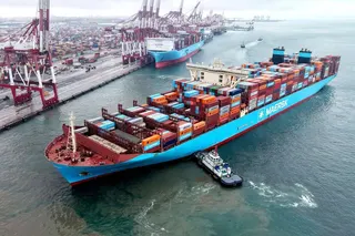 A container ship is moved into position at a port in China’s eastern Shandong province. Photo: AFP