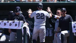 New York Yankees' Ben Rice high-fiving teammates after scoring a run