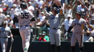 New York Yankees' Cody Bellinger running after scoring a run during a baseball game.