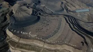 Getty Images Aerial view shows coal being loaded onto trucks near a coal mine in Datong, China's northern Shanxi province on November 2, 2021.