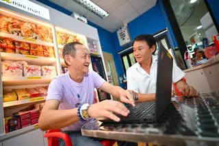 Alvin Teo Say Siong (left) with peer support specialist Alan Ng at the on-campus cafe where Teo is employed.