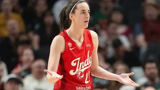 Caitlin Clark of the Indiana Fever reacting after a foul call during a basketball game.