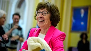 Sen. Susan Collins holding a blanket walking off the Senate floor at the U.S. Capitol Building