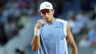 Matteo Arnaldi celebrating a point during a tennis match against Frances Tiafoe at the French Open.