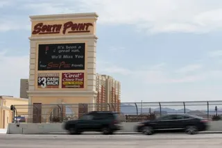 cars drive past a casino