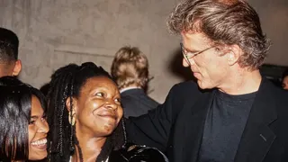 Nia Long, Whoopi Goldberg, and Ted Danson standing together at a movie premiere.