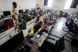 A police officer inspects a scam compound in Cambodia’s Kampot province in February. Photo: Reuters