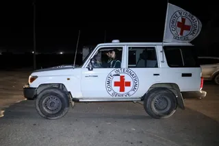 RAFAH, GAZA - NOVEMBER 30: Hostages are transported in International Committee of the Red Cross vehicles from the Gaza Strip through the Rafah land crossing on November 30, 2023 in Rafah, Gaza. Israel and Hamas agreed to a further extension to a truce that has lasted nearly a week, which promised the release of more Israeli hostages held in Gaza, as well as the release of Palestinian prisoners held in Israeli jails. (Photo by Ahmad Hasaballah/Getty Images)